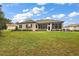 House with a screened-in porch and large backyard at 9450 Se 130Th Place Rd, Summerfield, FL 34491