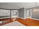 Hardwood floors, gray walls, and chandelier at 9450 Se 130Th Place Rd, Summerfield, FL 34491