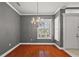 Gray walls, hardwood floors, and window with shutters at 9450 Se 130Th Place Rd, Summerfield, FL 34491