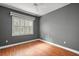 Bright bedroom with wood floors and window shutters at 9450 Se 130Th Place Rd, Summerfield, FL 34491