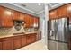 Well-equipped kitchen with stainless steel appliances and wood cabinets at 9450 Se 130Th Place Rd, Summerfield, FL 34491