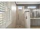 Walk-in shower with textured wall tiles and pebble flooring at 9450 Se 130Th Place Rd, Summerfield, FL 34491