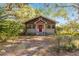 Charming one-story house with red front door and mature trees at 10135 Se 108Th Terrace Rd, Ocala, FL 34472