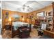 Bedroom with wood-paneled walls, a double bed, and ceiling fan at 10135 Se 108Th Terrace Rd, Ocala, FL 34472