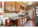 Kitchen features wood cabinets, granite countertops and copper accents at 10135 Se 108Th Terrace Rd, Ocala, FL 34472