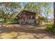 Charming one-story home with a red door and large oak trees at 10135 Se 108Th Terrace Rd, Ocala, FL 34472