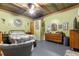 Cozy bedroom with wood-paneled walls, a comfortable bed, and a vintage dresser at 10135 Se 108Th Terrace Rd, Ocala, FL 34472