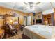Bedroom with ceiling fan, dresser, and a comfortable bed at 10135 Se 108Th Terrace Rd, Ocala, FL 34472