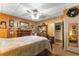 Bedroom with wood-paneled walls, a double bed, and a mirror at 10135 Se 108Th Terrace Rd, Ocala, FL 34472