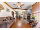 Spacious living room with hardwood floors, a fireplace, and large windows at 10135 Se 108Th Terrace Rd, Ocala, FL 34472