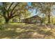 House with a large front yard surrounded by trees at 10135 Se 108Th Terrace Rd, Ocala, FL 34472
