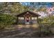 Quaint house exterior with red door and landscaping at 10135 Se 108Th Terrace Rd, Ocala, FL 34472
