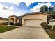 Single-story home with a two-car garage and well-maintained landscaping at 13552 Sw 81St Cir, Ocala, FL 34473