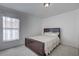 Bedroom with a dark wood bed frame and neutral bedding at 13552 Sw 81St Cir, Ocala, FL 34473