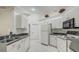 White kitchen features ample counter space and cabinets at 13552 Sw 81St Cir, Ocala, FL 34473