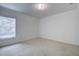 Bright bedroom with window, carpet, and double door closet at 13552 Sw 81St Cir, Ocala, FL 34473