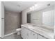 Bathroom with gray tiled shower, white vanity with granite countertop at 157 Fisher Ct, Ocklawaha, FL 32179