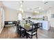 Open dining room with a large table and kitchen views at 227 Locust Pass Crse, Ocala, FL 34472