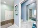 Elegant bathroom with a soaking tub, walk-in shower, and modern fixtures at 227 Locust Pass Crse, Ocala, FL 34472