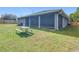 Home exterior view with covered patio and fenced backyard at 227 Locust Pass Crse, Ocala, FL 34472