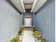 Inviting entryway with decorative plants and a light fixture at 227 Locust Pass Crse, Ocala, FL 34472