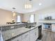 Modern kitchen with stainless steel appliances and granite counters at 227 Locust Pass Crse, Ocala, FL 34472