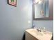 Clean and simple bathroom with a single vanity and mirror at 227 Locust Pass Crse, Ocala, FL 34472