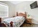 Cozy bedroom with a wooden bed frame, nightstand, and TV at 227 Locust Pass Crse, Ocala, FL 34472