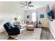 Gathering room with sectional sofa, ottoman and hardwood floors at 227 Locust Pass Crse, Ocala, FL 34472