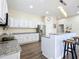 Spacious kitchen featuring granite countertops and an island with seating at 227 Locust Pass Crse, Ocala, FL 34472