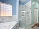 Spa-like bathroom with soaking tub and glass shower at 227 Locust Pass Crse, Ocala, FL 34472