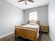 Bright bedroom with a wooden bed frame and nightstands at 227 Locust Pass Crse, Ocala, FL 34472