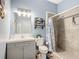 Bathroom with vanity, toilet, shower, and decorative accents at 227 Locust Pass Crse, Ocala, FL 34472