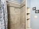 Shower stall with tiled walls and a patterned curtain at 227 Locust Pass Crse, Ocala, FL 34472