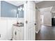 Small powder room with a unique vanity and view of entryway at 4535 Se 32Nd Pl, Ocala, FL 34480