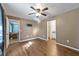Spacious bedroom with wood floors, ceiling fan, and access to bathroom at 1811 Ne 30Th St, Ocala, FL 34479