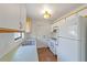 Bright kitchen features white cabinets, appliances, and a double sink at 1811 Ne 30Th St, Ocala, FL 34479