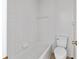Simple bathroom with white tile, toilet, and bathtub at 1811 Ne 30Th St, Ocala, FL 34479