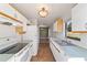 Open kitchen with white cabinets, black appliances, and view to dining area at 1811 Ne 30Th St, Ocala, FL 34479