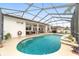 Relaxing pool area with covered patio, offering shade and comfort for outdoor enjoyment at 4736 Se 34Th St, Ocala, FL 34480