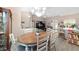 Open concept dining area with an oval table, offering views of the living room and kitchen at 4736 Se 34Th St, Ocala, FL 34480