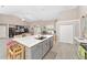 Open concept kitchen with large island, gray cabinets and white quartz countertops at 4736 Se 34Th St, Ocala, FL 34480