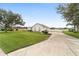 Single-story home showcasing a large driveway and lush lawn, offering parking and outdoor space at 4736 Se 34Th St, Ocala, FL 34480