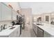 Modern kitchen with gray cabinets, expansive island, and stainless steel appliances at 4736 Se 34Th St, Ocala, FL 34480