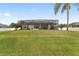 Large backyard with a view of the home's exterior, providing privacy and serenity at 4736 Se 34Th St, Ocala, FL 34480