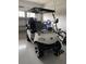 White golf cart parked in the garage at 10201 Sw 96Th Loop, Ocala, FL 34481
