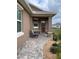 Inviting front porch with stone accents and rocking chairs at 10201 Sw 96Th Loop, Ocala, FL 34481