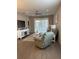 Spacious living room featuring a cozy recliner and wood-look floors at 10201 Sw 96Th Loop, Ocala, FL 34481