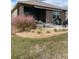 Landscaped backyard with patio, seating area, and pink muhly grass at 10201 Sw 96Th Loop, Ocala, FL 34481