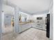 Kitchen features white cabinets, granite countertops, and stainless steel appliances at 17789 Se 113Th Ter, Summerfield, FL 34491